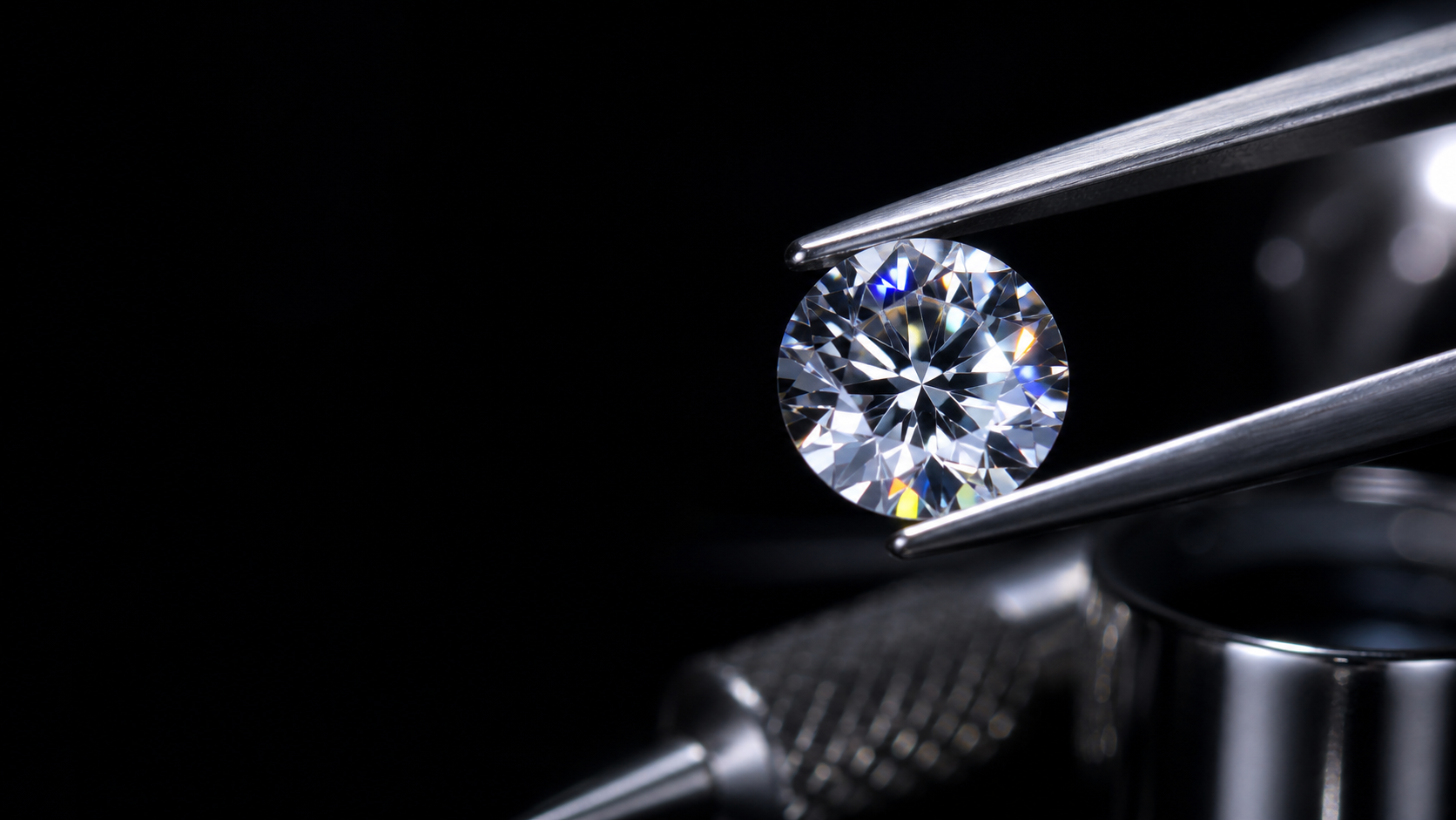 A brilliant-cut diamond gripped by precision tweezers under dramatic light